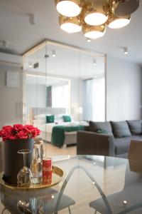 una sala de estar con una mesa con rosas. en GA Luxury Apartments M45, en Cracovia