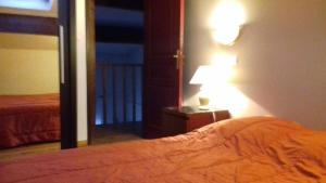 サン・ジルにあるAppartement Anatole Franceのベッドルーム(ベッド1台、ランプ、バルコニー付)