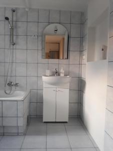 a white bathroom with a sink and a mirror at Agroturystyka Skrzeczówka in Krajno Pierwsze