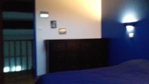 a bedroom with a bed with a blue blanket and lights at Appartement Anatole France in Saint-Gilles +2 photos