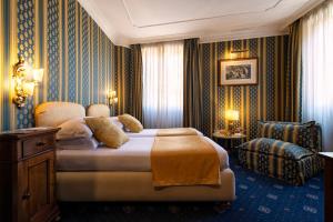 a hotel room with a bed and a chair at Atlante Star Hotel in Rome +65 photos