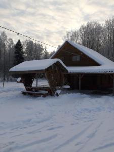 a house with snow on top of it at Huntingbox in Purila +7 photos