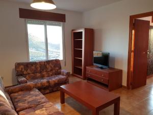 a living room with a couch and a tv at Catalejo 5 Aguilas,Murcia in Águilas