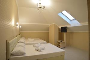 a room with three beds and a skylight at Hotel LeMan in Kabardinka