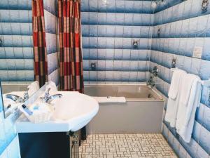 a bathroom with a sink and a bath tub at Hotel Motel La Marquise in Sherbrooke +32 photos