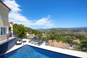 a villa with a swimming pool on top of a house at Villa Mar in Calpe