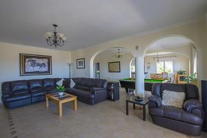 a living room with couches and a pool table at Villa Anuska - Plusholidays in Calpe