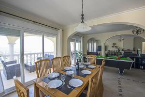 a dining room with a table and a pool table at Villa Anuska - Plusholidays in Calpe