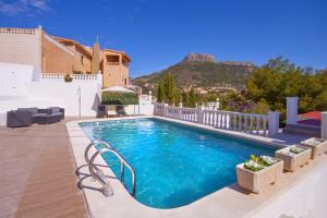 a swimming pool in the middle of a house at Villa Jazmin in Calpe