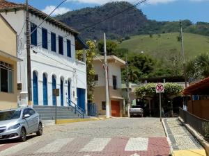 a street in a town with a hill in the background at Casinhas Interior Mg in Antônio Prado