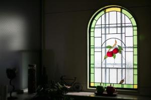 a stained glass window with a bird and fruit on it at Nagoya - Hotel / Vacation STAY 19141 in Nagoya
