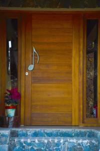 a wooden door of a house with a potted plant at Melodias Posada Boutique in Los Reartes