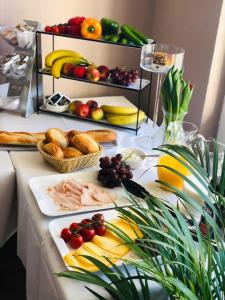 a table with a buffet of food and fruits and vegetables at Motel Blue - Minimalist Boutique Hotel in Berlin +22 photos