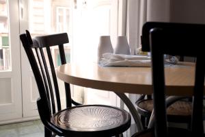 drewniany stół i krzesła w pokoju ze stołem i oknem w obiekcie B&B Il Sorriso w mieście Napoli