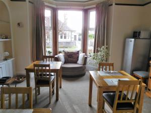 a living room with a table and chairs and a couch at The Castle B&B in Inverness