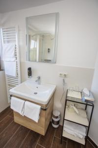 a bathroom with a sink and a mirror at Landgasthof Druschel in Schlüchtern