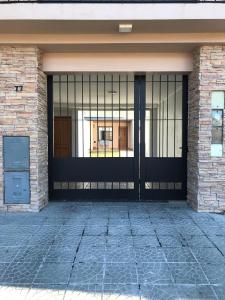 a front door of a building with a gate at Departamento a 200 mts de la laguna in Chascomús