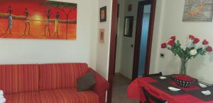 a living room filled with furniture and a red couch at Orchid in Olbia
