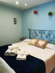 a bedroom with a large bed with towels on it at Albatros House in L'Escala