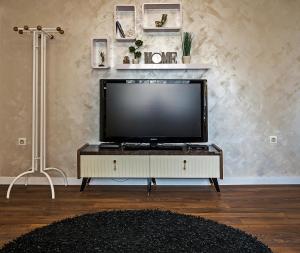 a flat screen tv sitting on a tv stand in a living room at Guest House Amaya in Plovdiv