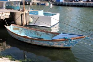 a boat tied to a dock in the water at Studio 237 Port Camargue, Piscine, Climatisation, 2 personnes in Le Grau-du-Roi