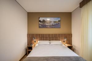 Tempat tidur dalam kamar di Hotel Fioreze Primo