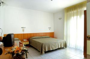 Postel nebo postele na pokoji v ubytování Hotel Nel Pineto