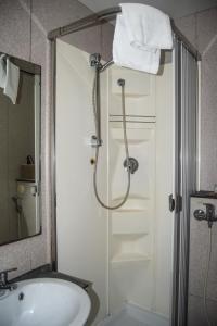 a bathroom with a shower with a sink and a shower at Soggiorno La Cupola Guesthouse in Florence