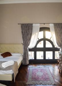 a bedroom with two beds and a large window at Soggiorno La Cupola Guesthouse in Florence
