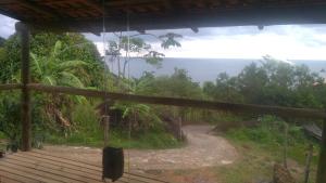 a view from the porch of a house looking down a dirt road at Mirante in Trindade
