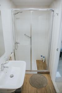 a bathroom with a shower and a white sink at Home Bassou in Santa Cruz de Tenerife