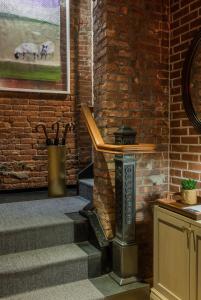a stone wall with a fire place next to a brick wall at Merrion Row Hotel and Public House in New York
