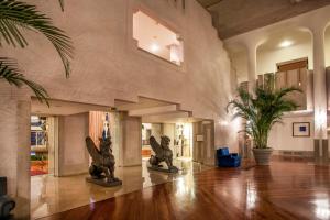 a living room with two statues in the middle of the room at Hotel Excelsior Venice in Venice-Lido