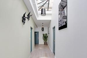 un couloir d'une maison aux murs blancs dans l'établissement Rent a Room - Residence Meslay, à Paris