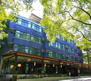 埔里埔里麒麟山庄的一座大型蓝色建筑,设有玻璃窗