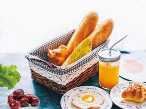 a basket of bread and a basket of eggs and fruit at Pullman Xiamen Powerlong in Xiamen