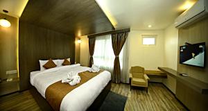 Ένα ή περισσότερα κρεβάτια σε δωμάτιο στο The Milestone Hotel