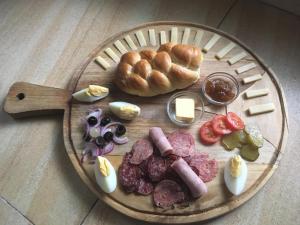 a plate of food with sausage and bread and vegetables at Buenaventura Beachresort in Nauhang