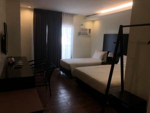 Postel nebo postele na pokoji v ubytování Piña Suites