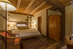 a bedroom with a bed and a table and chairs at Serena Shigar Fort in Shigar