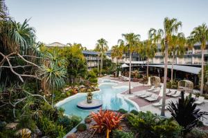 an image of a resort pool with palm trees at Mantra Club Croc in Airlie Beach