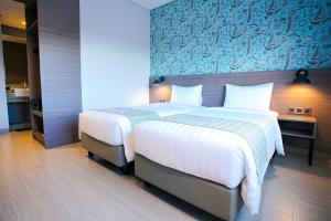 Postel nebo postele na pokoji v ubytování BW inn Belitung