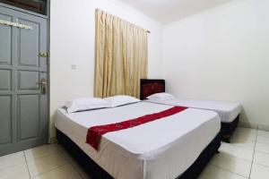 سرير أو أسرّة في غرفة في Wisma Lamida 2 Syariah