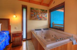 a bathroom with a large tub in a bedroom at Maleny Tropical Retreat in Maleny +77 photos