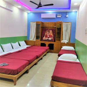 a room with two beds and a ceiling at Jayaram Residency Tirupathi in Tirupati