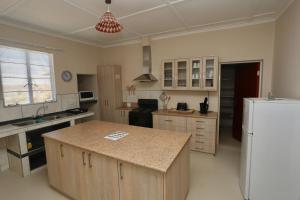 a kitchen with a white refrigerator and a counter top at Aloe Rock House in Aus