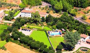 an aerial view of a mansion with a garden and a swimming pool at Cortona Resort & Spa - Villa Aurea in Cortona