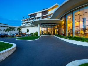 a large building with a driveway in front of it at Grand Lagoi Hotel Bintan in Lagoi