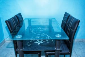 a blue table with two black chairs around it at KJ Gold House Senggigi in Senggigi  +7 photos