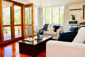 a living room with two couches and a coffee table at Nagoondie Studio in Healesville